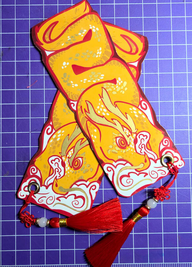 Front and back of Dragon Bookmarks; Printed, Cut, assembled, and laminated.